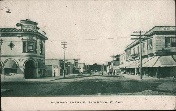 Historic black and white postcard showing Murphy Avenue in early Sunnyvale with period buildings, utility poles, and unpaved street